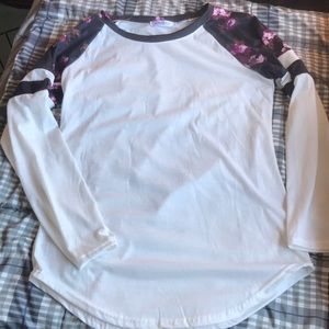 3/$15. Long sleeved cotton feel tee with floral accent